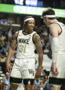 Wake Forest guard Alondes Williams (31) and forward Jake Laravia (0) celebrate during the first half of an NCAA college basketball game against North Carolina on Saturday, Jan. 22, 2022, in Winston-Salem, N.C. (Allison Lee Isley/The Winston-Salem Journal via AP)