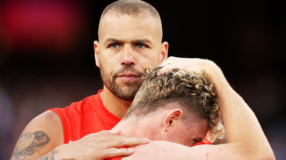 Buddy Franklin consoles teammate Chad Warner after Sydney's AFL grand final loss to Geelong.