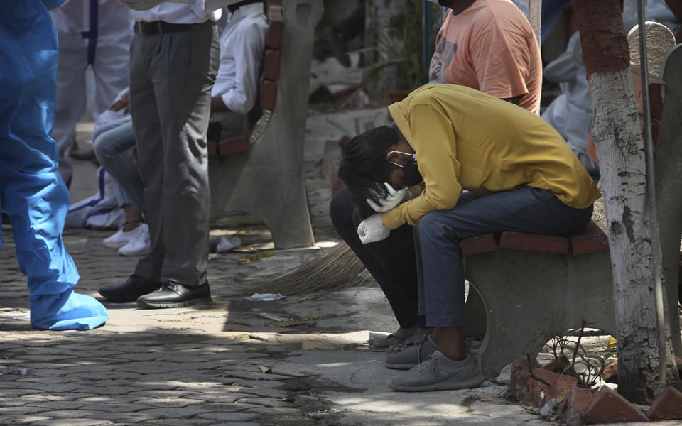 Man cries outside hospital in India.