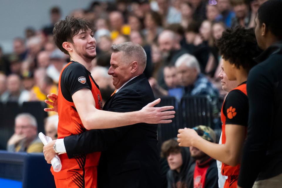 Central York head coach Jeff Hoke greets senior Greg Guidinger as he checks out in the final minute of a PIAA Class 6A second round game against Red Lion on March 13, 2024, at Dallastown Area High School. Guidinger set Central York's all-time scoring record this season.