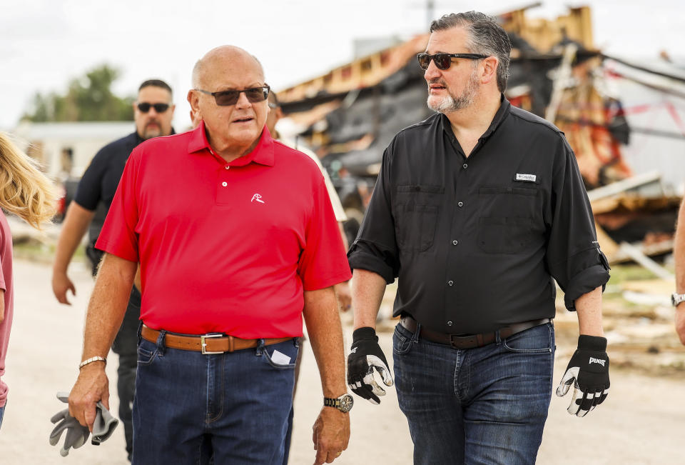 Mayor Kerry Symons walks with U.S. Sen. Ted Cruz, R-Texas, as they survey the damage left behind after a tornado in Perryton, Texas, Saturday, June 17, 2023. (AP Photo/David Erickson)