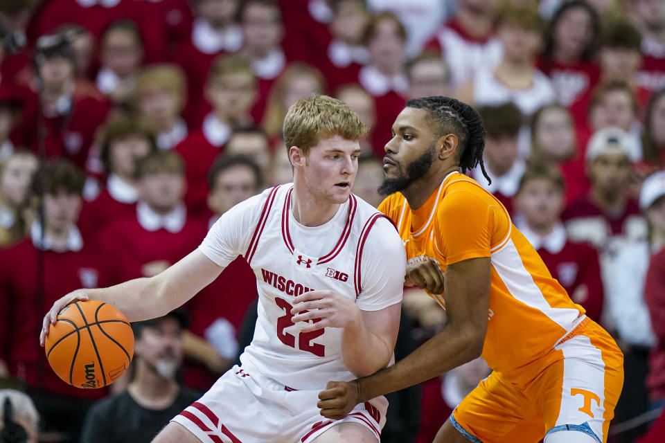 Wisconsin's Steven Crowl (22) drives against Tennessee's Jonas Aidoo, right, during the first half of an NCAA college basketball game Friday, Nov. 10, 2023, in Madison, Wis. (AP Photo/Andy Manis)