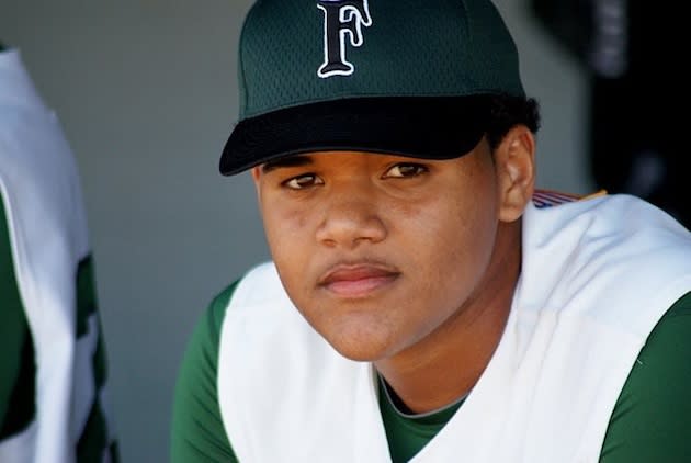 Flanagan pitcher Jose Mesa Jr. in his team's dugout — Facebook