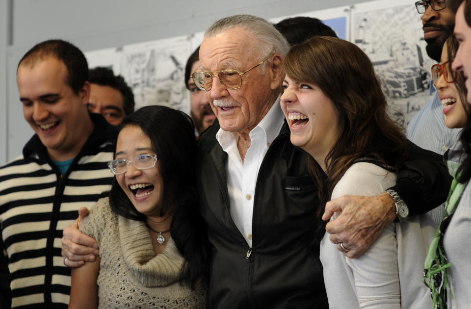 Legendary comic creator Stan Lee poses with students at the Savannah College of Art and Design while visiting the college to critique some of the work by graduate and undergraduate students in the sequential art program in Savannah, Ga., on Wednesday, Oct. 31, 2012. Lee, the 89-year-old co-creator of Spider-Man, dropped in on the school after being honored at the SCAD Savannah Film Festival. (AP Photo/Stephen Morton)