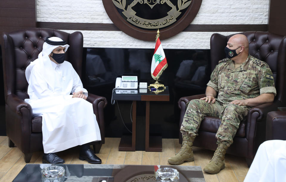 FILE - In this photo released by the Lebanese Army official website, Lebanese Army Commander Gen. Joseph Aoun, right, meets with Qatar's Deputy Prime Minister and Foreign Minister Sheikh Mohammed bin Abdulrahman bin Jassim Al-Thani, at the defense ministry, in Beirut, Lebanon, Tuesday, July 6, 2021. (Lebanese Army Website via AP, File)