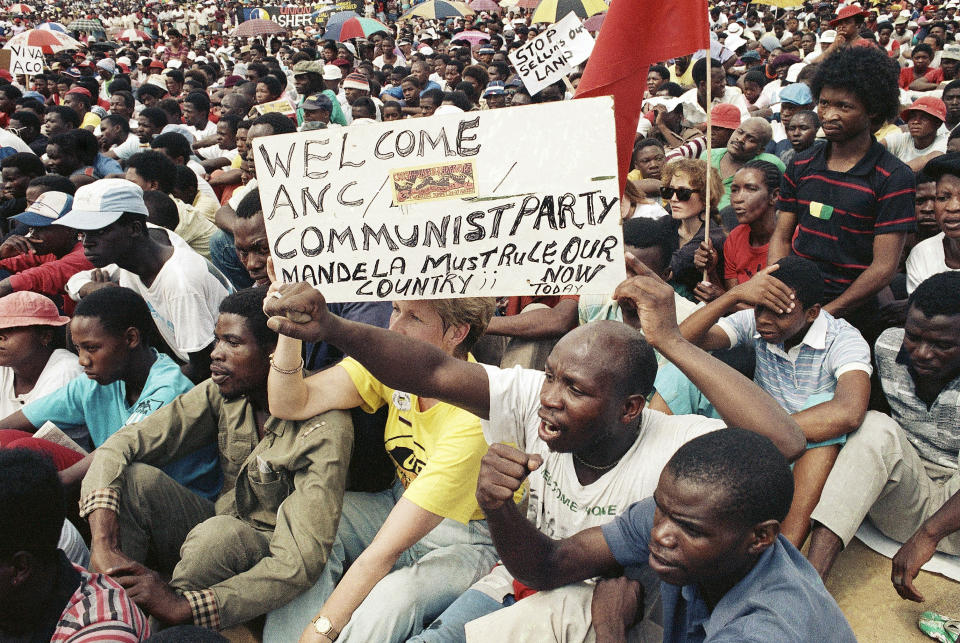 FILE - Anti-government protesters chant and sing at a rally in Alexandra Township, Feb. 3, 1990, in Johannesburg, the day after state President de Klerk announced the unbanning of the African National Congress and other anti-apartheid organizations. South Africa is engrossed in debate over the legacy of apartheid's last president, de Klerk, who died at 85 and is to be buried Sunday, Nov 21, 2021. Some people want to remember de Klerk as the liberator of Nelson Mandela, but others say he was responsible for racist murders. (AP Photo/Raymond Preston, File)