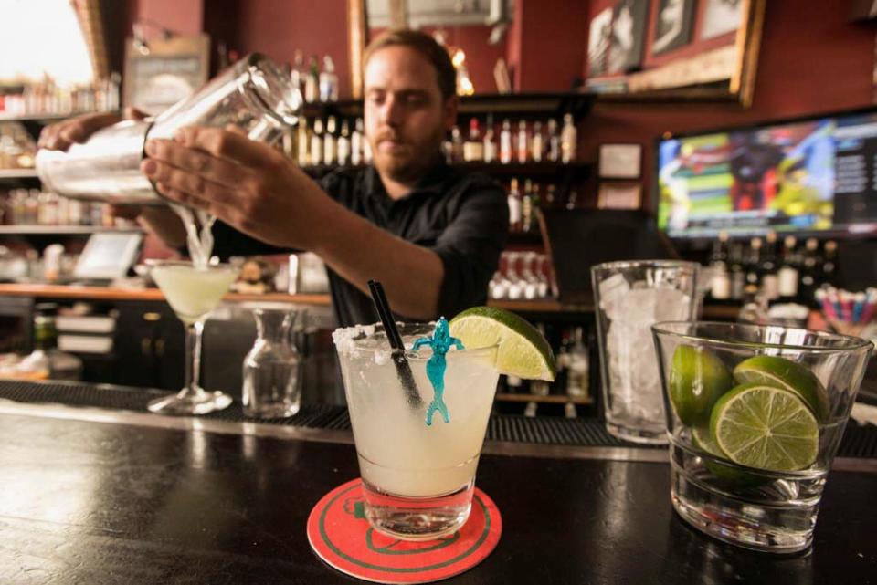 In this Monday, April 28, 2014 photo, bartender Scott Luhrs crafts cocktails at the bar of Luna Park restaurant in Los Angeles. Thousands of restaurateurs from coast to coast who have fallen victim to the Great Green Citrus Crisis of 2014. The price of a lime has skyrocketed in recent weeks, quadrupling or, in some areas, going even higher. (AP Photo)