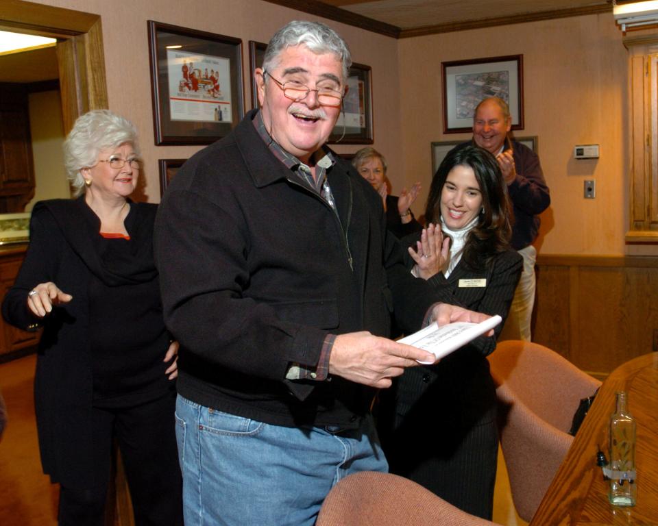 File photo - Dino Cortopassi was surprised on Dec. 9, 2005 at his home with the news that he had been chosen as the Stocktonian of the Year.  Presenting him with the message in a bottle is Linda Roybal. In back left is his wife Joan Cortopassi, and in back right is former winner Joe Crane.