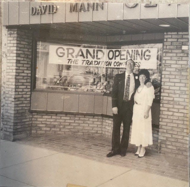 David Mann and his wife celebrate the grand opening of their jewelry store, David Mann Jewelers. The store was renamed following the retirement of his in-laws.