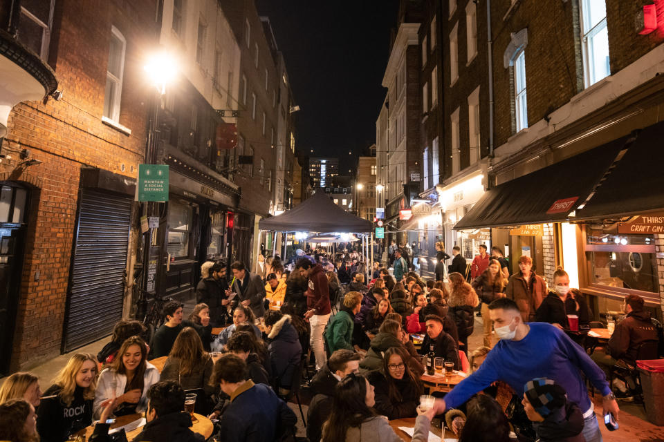 People gather in Soho, London, where streets were closed to traffic as bars and restaurants opened for outside eating and drinking, as lockdown measures are eased across the UK. Picture date: Tuesday April 13, 2021. Photo credit should read: Matt Crossick/Empics