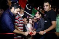 Syeda Shehla Raza, nominated candidate of the Pakistan Peoples Party (PPP) for the National Assembly seat from Karachi, along with party workers, cuts a ribbon to inaugurate campaign office in her constituency, ahead of general elections in Karachi, Pakistan July 10, 2018. Picture taken July 10, 2018. REUTERS/Akhtar Soomro