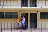 Judith and Jose Ramirez pose with their daughters outside their unit at an apartment complex in Honolulu