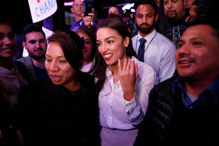 FILE PHOTO: Democratic congressional candidate Alexandria Ocasio-Cortez greets supporters at her midterm election night party in New York City, U.S. November 6, 2018. REUTERS/Andrew Kelly/File Photo