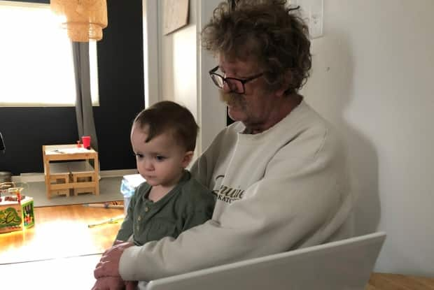 Richard Baron holds one of his grandchildren. The 64-year-old Regina resident was just diagnosed with cancer that has spread to his brain.  (Submitted by Ashleigh Woytuik - image credit)