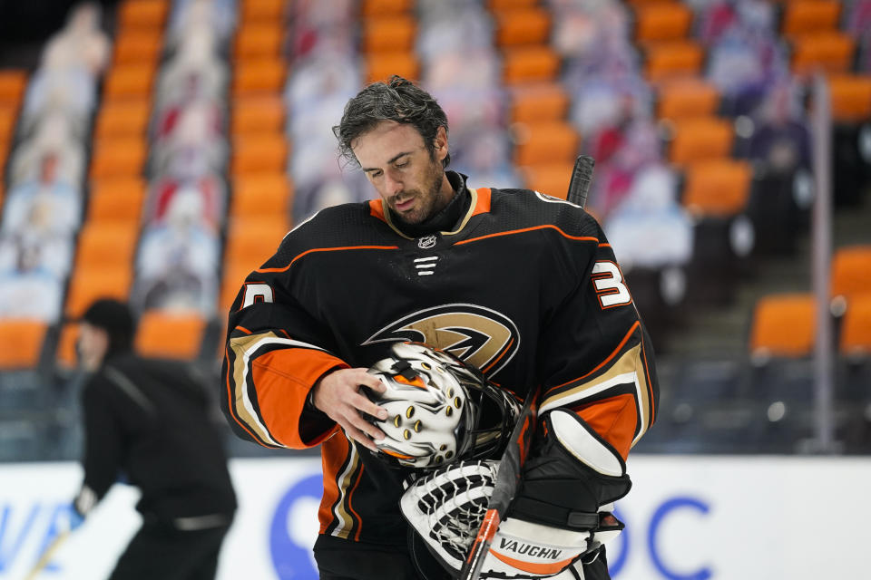 FILE - Anaheim Ducks goaltender Ryan Miller takes off his mask during the first period of an NHL hockey game against the Arizona Coyotes in Anaheim, Calif., in this Saturday, March 20, 2021, file photo. Ducks goalie Ryan Miller will retire at the conclusion of the season, ending the 18-year career of the winningest American-born goaltender in NHL history. The 40-year-old Miller announced his decision Thursday, April 29, 2021. (AP Photo/Jae C. Hong, File)