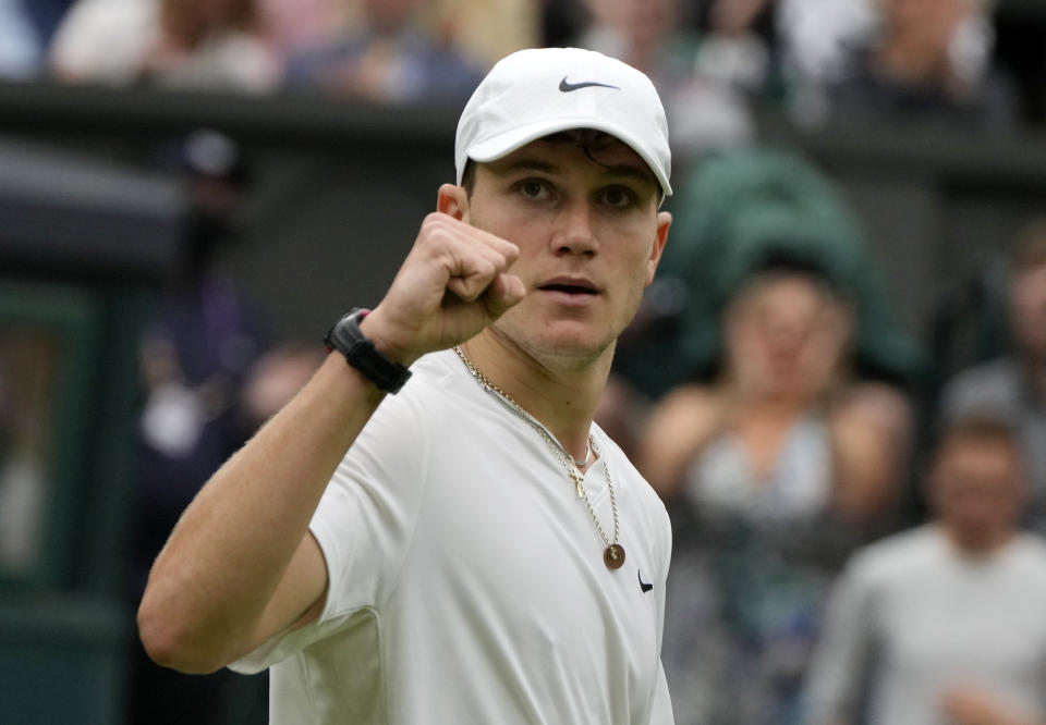 Britain's Jack Draper celebrates winning the first set against Serbia's Novak Djokovic during their first round men's singles match on day one of the Wimbledon Tennis Championships in London, Monday June 28, 2021. (AP Photo/Kirsty Wigglesworth)
