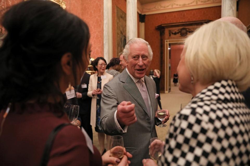 King Charles III speaks to guests during a reception to celebrate small and medium-sized businesses at Buckingham Palace on November 16, 2022 in London, England.