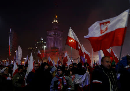 People carry Polish flags during a march marking the 100th anniversary of Polish independence in Warsaw, Poland November 11, 2018. REUTERS/Kacper Pempel