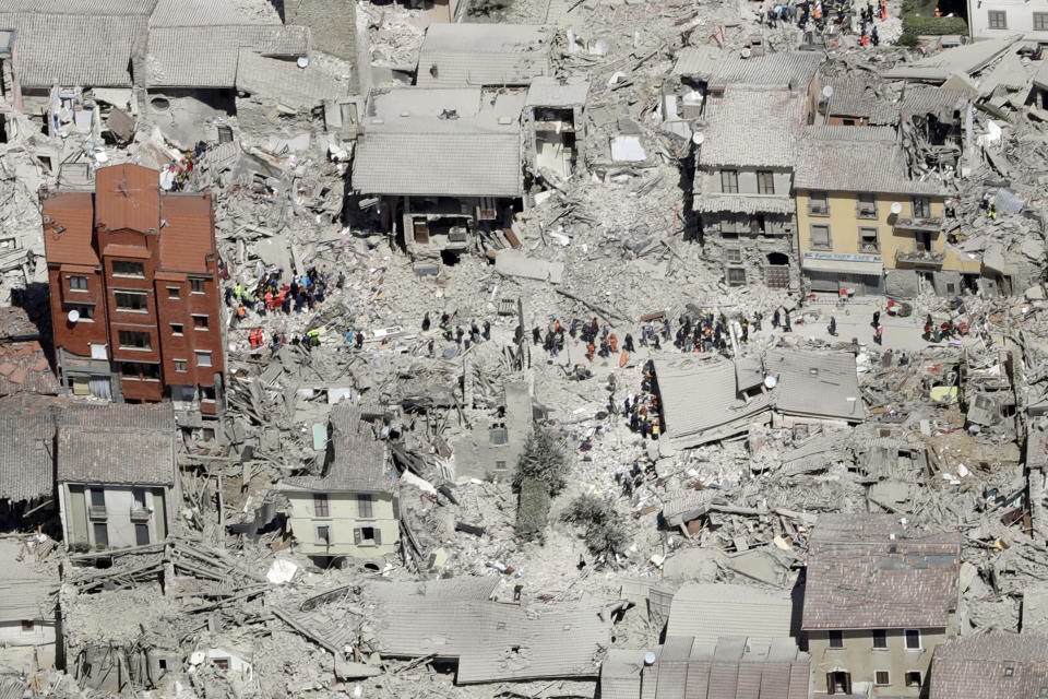 FILE - In this Wednesday, Aug. 24, 2016 file photo, an aerial photo shows the damaged buildings in the town of Amatrice, central Italy, after an earthquake. The Italian town of Amatrice, hardest hit by an earthquake last month, has filed Monday, Sept. 12, 2016, a criminal complaint denouncing French satirical weekly Charlie Hebdo for a cartoon depicting victims in layers of lasagna. (AP Photo/Gregorio Borgia, File)