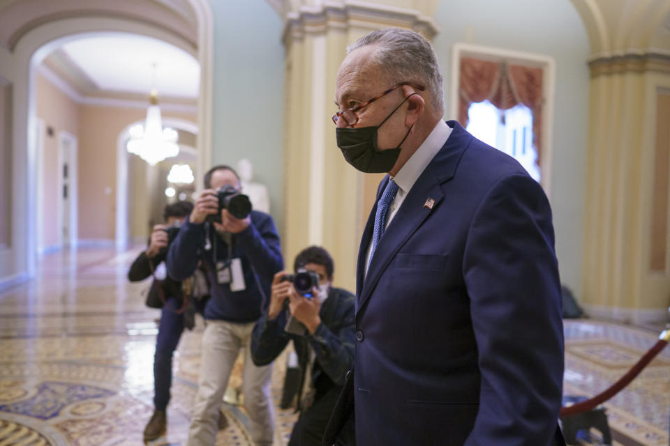 FILE - In this Feb. 12, 2021, file photo Senate Majority Leader Chuck Schumer, D-N.Y., returns to the chamber as the defense finishes arguments in the impeachment trial of former President Donald Trump, in Washington.. (AP Photo/J. Scott Applewhite, File)