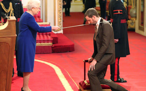 Wiggins is knighted by the Queen - Credit: PA