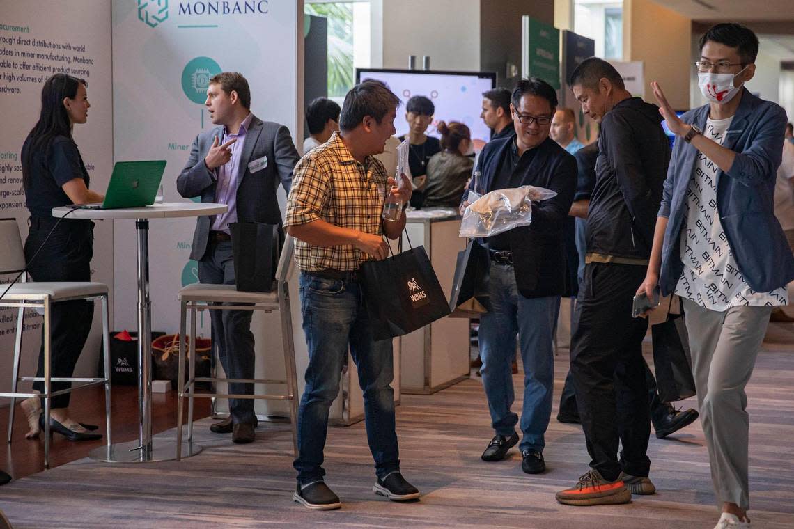 People discuss cryptocurrency at the various booths during the World Digital Mining Summit at the Mandarin Oriental in Miami, Florida on Tuesday, July 26, 2022.