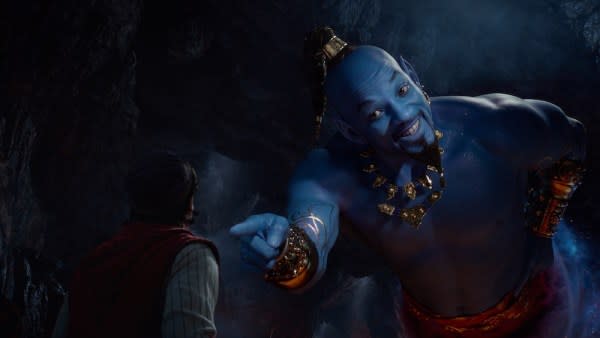 Aladdin (Mena Massoud) meets the larger-than-life blue Genie (Will Smith) in Aladdin. Credit: Walt Disney Pictures