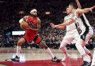 Toronto Raptors guard Gary Trent Jr. (33) is defended by San Antonio Spurs forward Zach Collins (23) during the first half of an NBA basketball game Wednesday, Feb. 8, 2023, in Toronto. (Arlyn McAdorey/The Canadian Press via AP)
