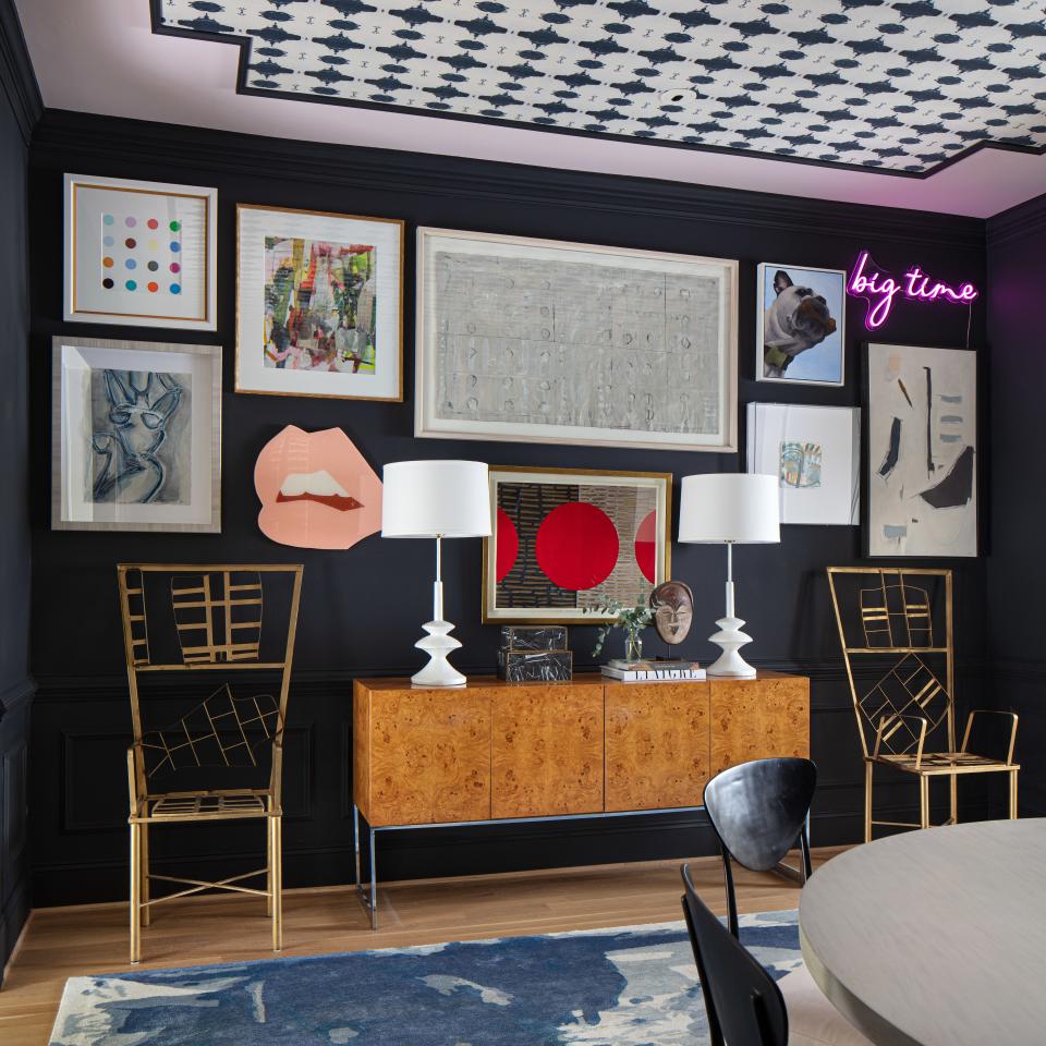 In the dining room, a vintage credenza topped with Mr. Brown lamps is flanked by vintage chairs from interior designer Kelly Wearstler's Beverly Hills home. Lindsay created a gallery wall to highlight some of her favorite pieces by artists Holly Addi, Addie Chapin, Susan Carter Hall, and Angela Chrusciaki Blehm. “That gallery wall went through many iterations,” she says. “It’s about finding the right place for them and creating the right tension between the art.”