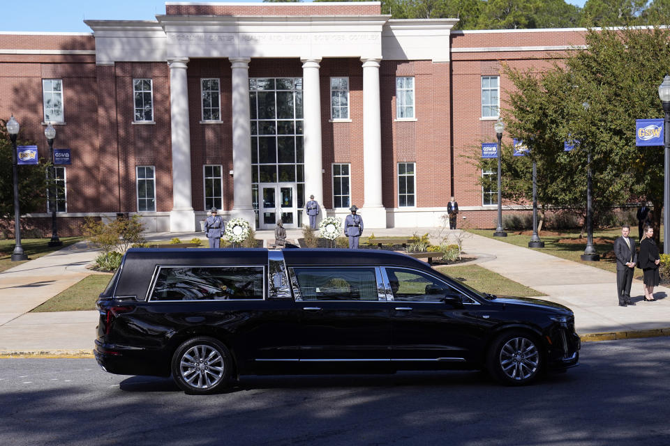 The hearse carrying casket of former first lady Rosalynn Carter pauses as family members participate in a wreath laying ceremony at the Rosalynn Carter Health & Human Services complex on the campus of Georgia Southwestern State University, Monday, Nov. 27, 2023, in Americus, Ga. The former first lady died on Nov. 19. She was 96. (AP Photo/John Bazemore, Pool)