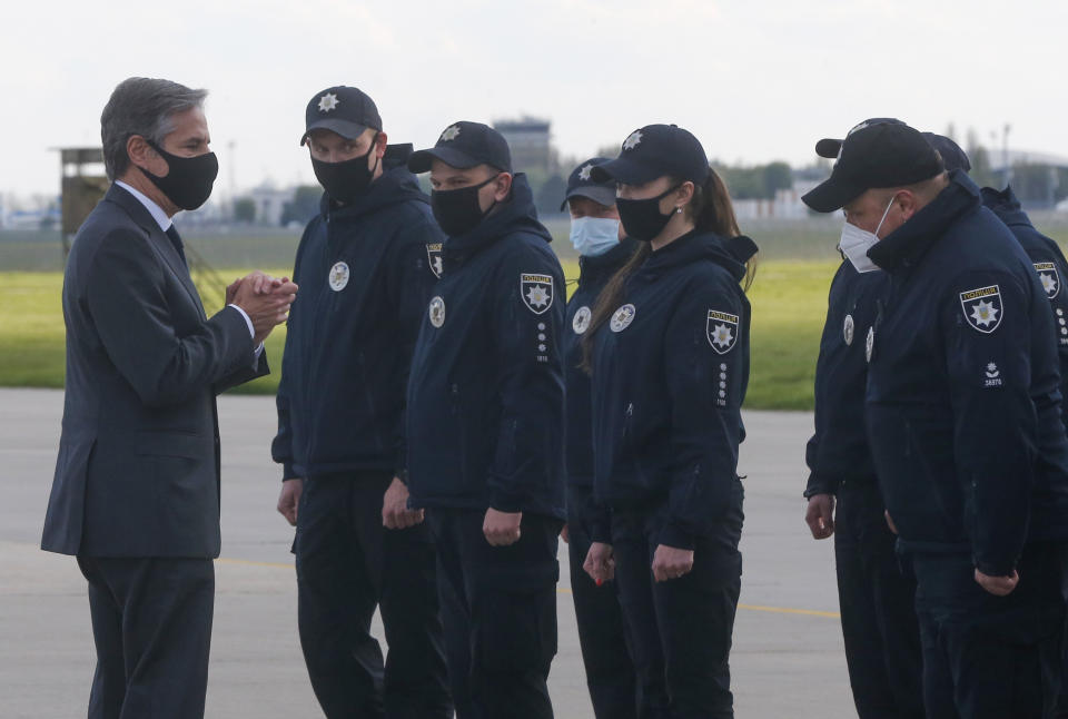 U.S. Secretary of State Antony Blinken greets Ukrainian policemen upon departure from Boryspil International airport outside Kyiv, Ukraine, Thursday, May 6, 2021. U.S. Secretary of State Antony Blinken has met with top Ukrainian officials in Kyiv and reaffirmed Washington's support for the country in the wake of heightened tensions with Russia. (AP Photo/Efrem Lukatsky, Pool)