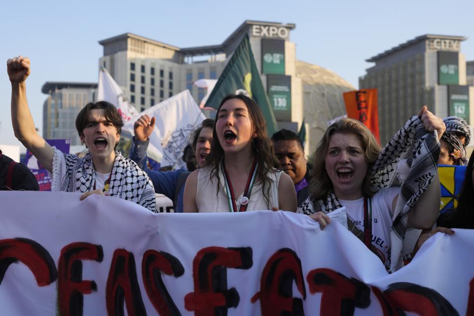 Activists demonstrate for climate justice and a ceasefire in the Israel-Hamas war at the COP28 U.N. Climate Summit, Saturday, Dec. 9, 2023, in Dubai, United Arab Emirates. (AP Photo/Rafiq Maqbool)