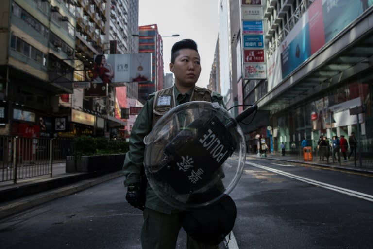 A Hong Kong riot policewoman stands on a cordoned-off street on February 9, 2016