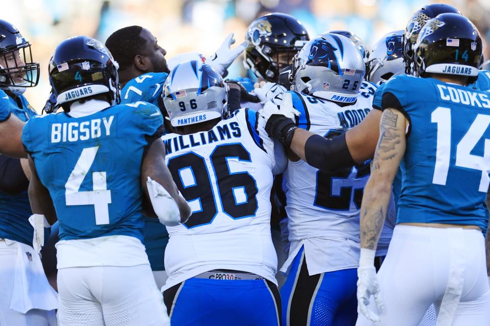 Jacksonville Jaguars offensive tackle Cam Robinson (left without helmet) got into an alteraction with Carolina Panthers defensive tackle Derrick Brown during the fourth quarter of Sunday's 26-0 Jaguars victory over the Panthers, at EverBank Stadium.