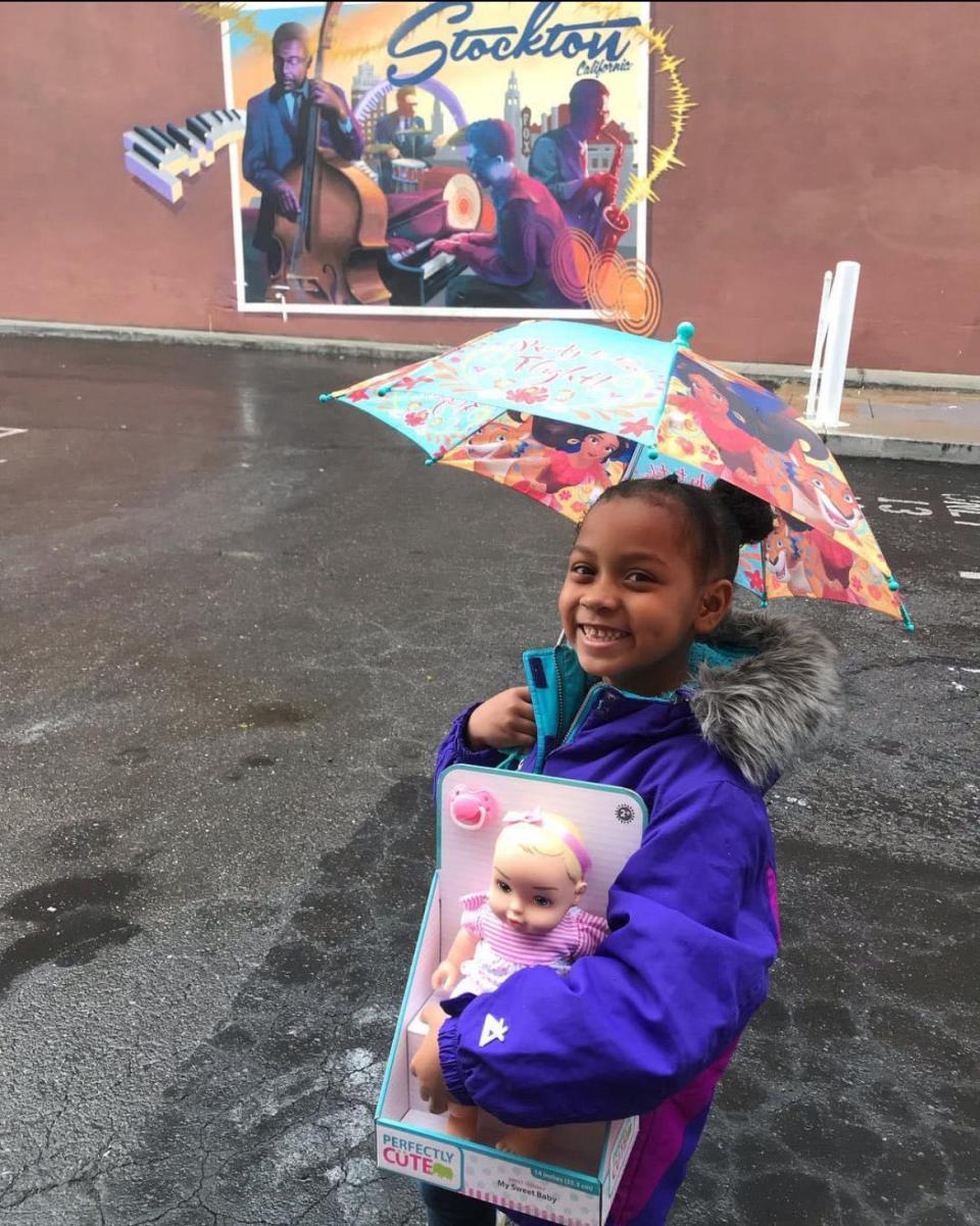 Natalia Clark, 5, poses for the camera holding the baby doll she bought with her lemonade stand earnings for the little girl whose family lost everything during the Camp Fire. (Photo taken on Nov. 21, 2018.)