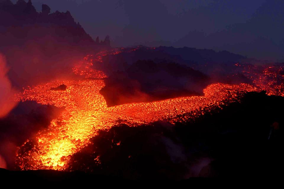 Lava and smoke rises from Mount Etna on the southern Italian island of Sicily on September 11, 2004. A new fissure yawned open on the south eastern side of Sicily's Mount Etna volcano on Tuesday, oozing out enough lava to cross a city block, researchers said. REUTERS/Antonio Parrinello Pictures of the month September 2004 NO RIGHTS CLEARANCES OR PERMISSIONS ARE REQUIRED FOR THIS IMAGE  TG/THI