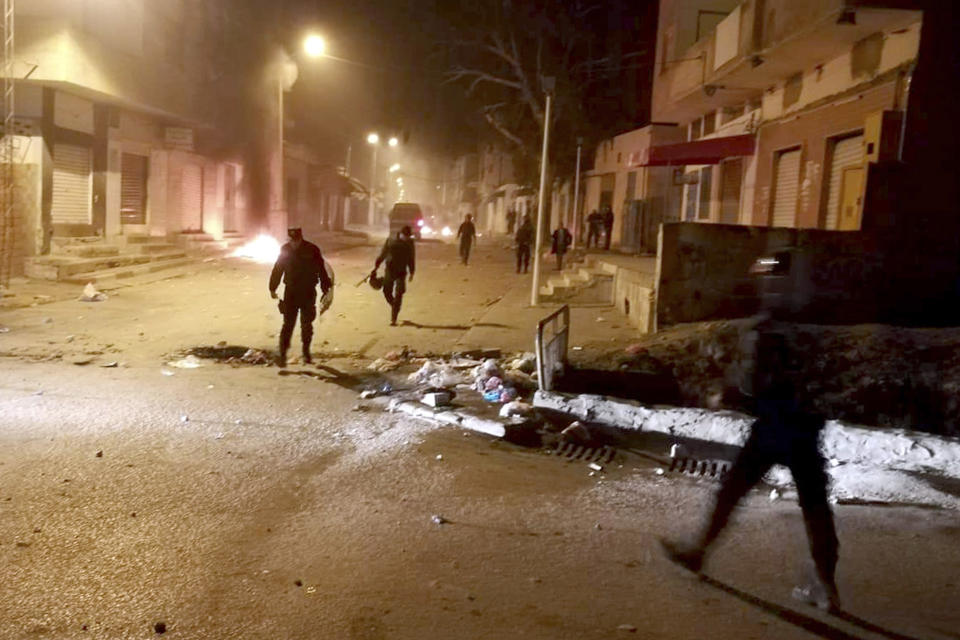 Tunisian Police officers patrol after clashes in the streets of Kasserine, southern of Tunisia, Tuesday, Dec 25, 2018.The death of a Tunisian journalist Abderrak Zorgui who set himself on fire to protest economic problems in the North African nation prompted a protest that led to clashes with police and nationwide concern. (AP Photo/Mohamed Ben Salah)