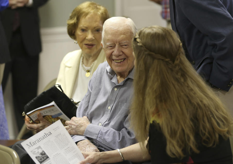 Former President Jimmy Carter talks with neighbor Stephanie Wynn before the start of bible study at Maranatha Baptist Church in Plains, Ga., on Sunday morning, Aug. 16, 2015. (Ben Gray/ The Atlanta Journal-Constitution via AP)