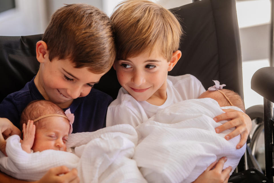 Grant and Cooper snuggled up with their sisters.  (Tate Tullier Photography)