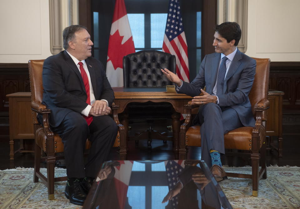 Canadian Prime Minister Justin Trudeau gestures to U.S. Secretary of State Mike Pompeo as they speak on Parliament Hill in Ottawa, Thursday Aug. 22, 2019. (Adrian Wyld/The Canadian Press via AP)