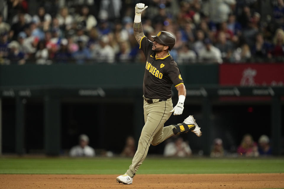 San Diego Padres' David Peralta celebrates his two-run home run against the Texas Rangers in the seventh inning of a baseball game Wednesday, July 3, 2024 in Arlington, Texas. Donovan Solano also scored on the shot. (AP Photo/Tony Gutierrez)