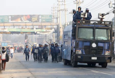 Police chase garments workers who have been protesting for higher wages, with water cannon at Ashulia, outskirt of Dhaka, Bangladesh, January 14, 2019. REUTERS/Mohammad Ponir Hossain