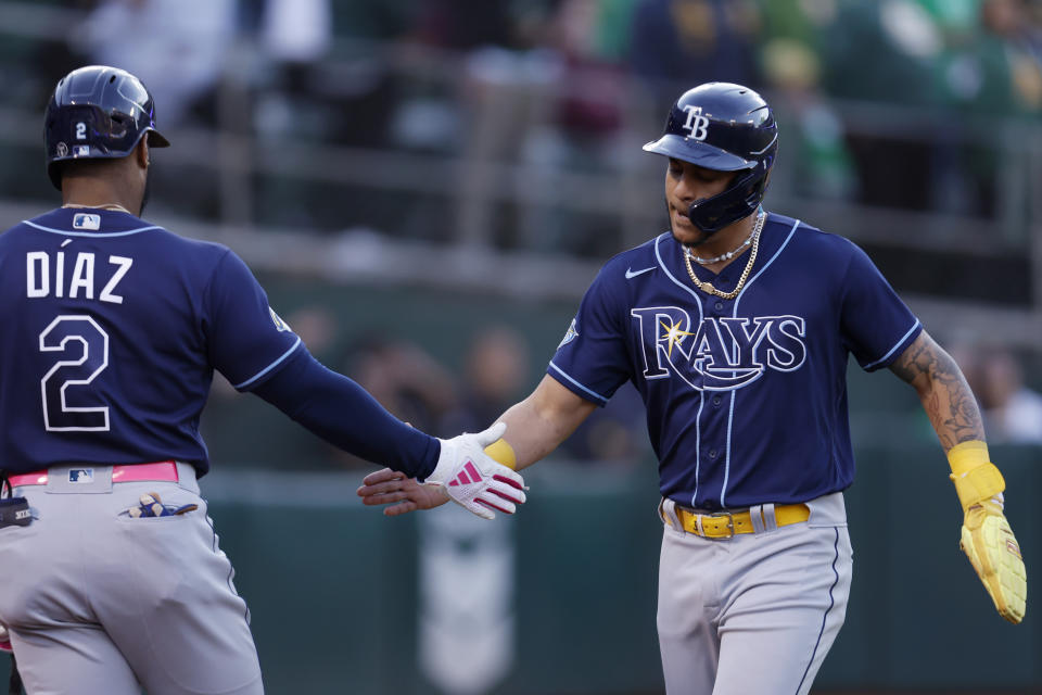 Tampa Bay Rays' Jose Siri, right, is congratulated by Yandy Diaz after scoring on a single by Manuel Margot during the fifth inning of the team's baseball game against the Oakland Athletics in Oakland, Calif., Tuesday, June 13, 2023. (AP Photo/Jed Jacobsohn)