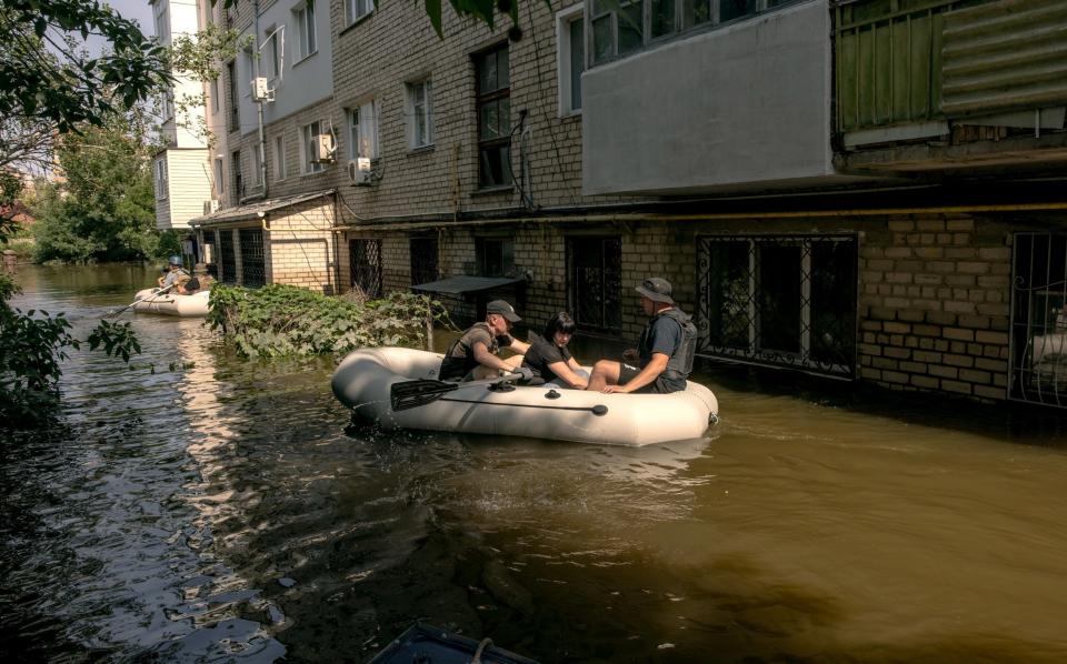 *** BESTPIX *** KHERSON, UKRAINE - JUNE 09: A woman sits in an inflatable boat after she was evacuated by volunteers from an apartment building on a flooded street on June 9, 2023 in Kherson, Ukraine. Early Tuesday, the Kakhovka dam and hydroelectric power plant, which sit on the Dnipro river in the southern Kherson region, were destroyed, forcing downstream communities to evacuate due to the risk of flooding. The cause of the dam's collapse is not yet confirmed, with Russia and Ukraine accusing each other of its destruction. The Dnipro river has served as a frontline between the warring armies following Russia's retreat from Kherson and surrounding areas last autumn. The dam and plant had been under the control of Russia, which occupies a swath of land south and southeast of the river. (Photo by - Roman Pilipey/Getty Images