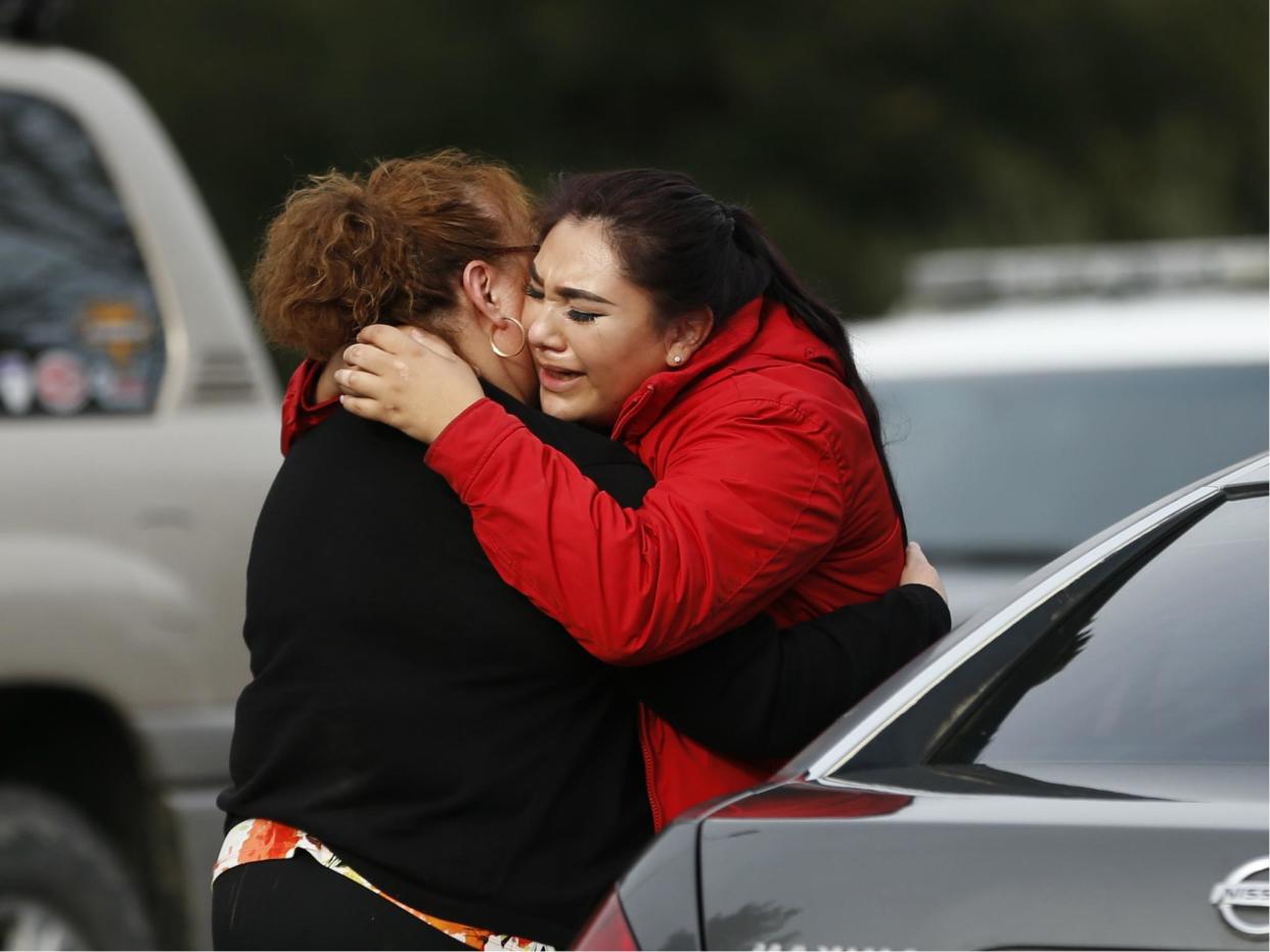 Vanessa Flores embraces another woman after she leaves the locked down Veterans Home of California during an active shooter turned hostage situation on 9 March 2018 in Yountville, California: Stephen Lam/Getty Images