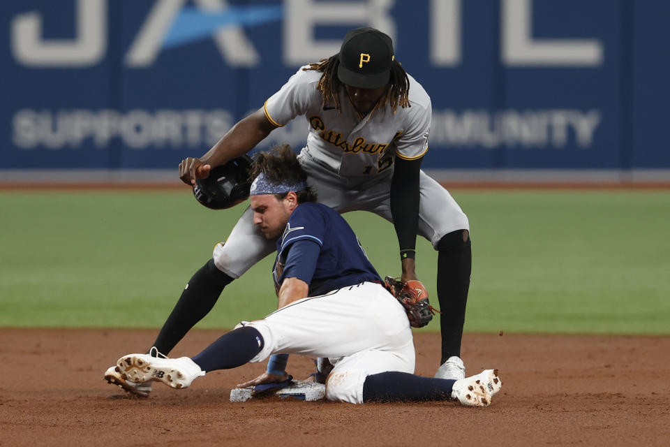 Tampa Bay Rays' Josh Lowe steals second base, beating the tag of Pittsburgh Pirates shortstop Oneil Cruz during the second inning of a baseball game Friday, June 24, 2022, in St. Petersburg, Fla. (AP Photo/Scott Audette)