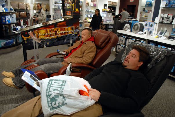 The massage chairs inside of The Sharper Image store at the mall: