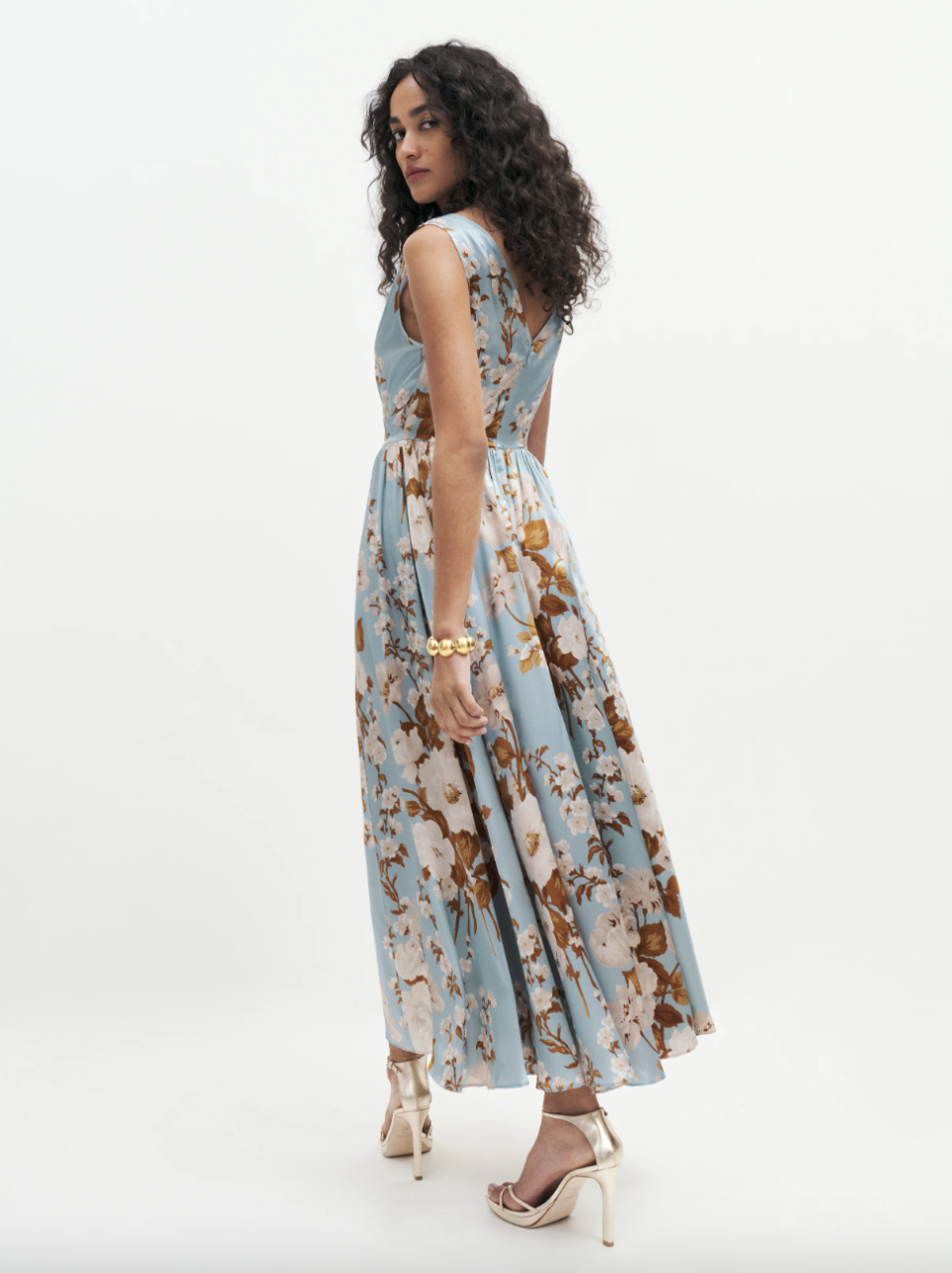 reformation model wearing pattern blue, white and brown silk midi dress, Blu Silk Dress (Photo via Reformation)