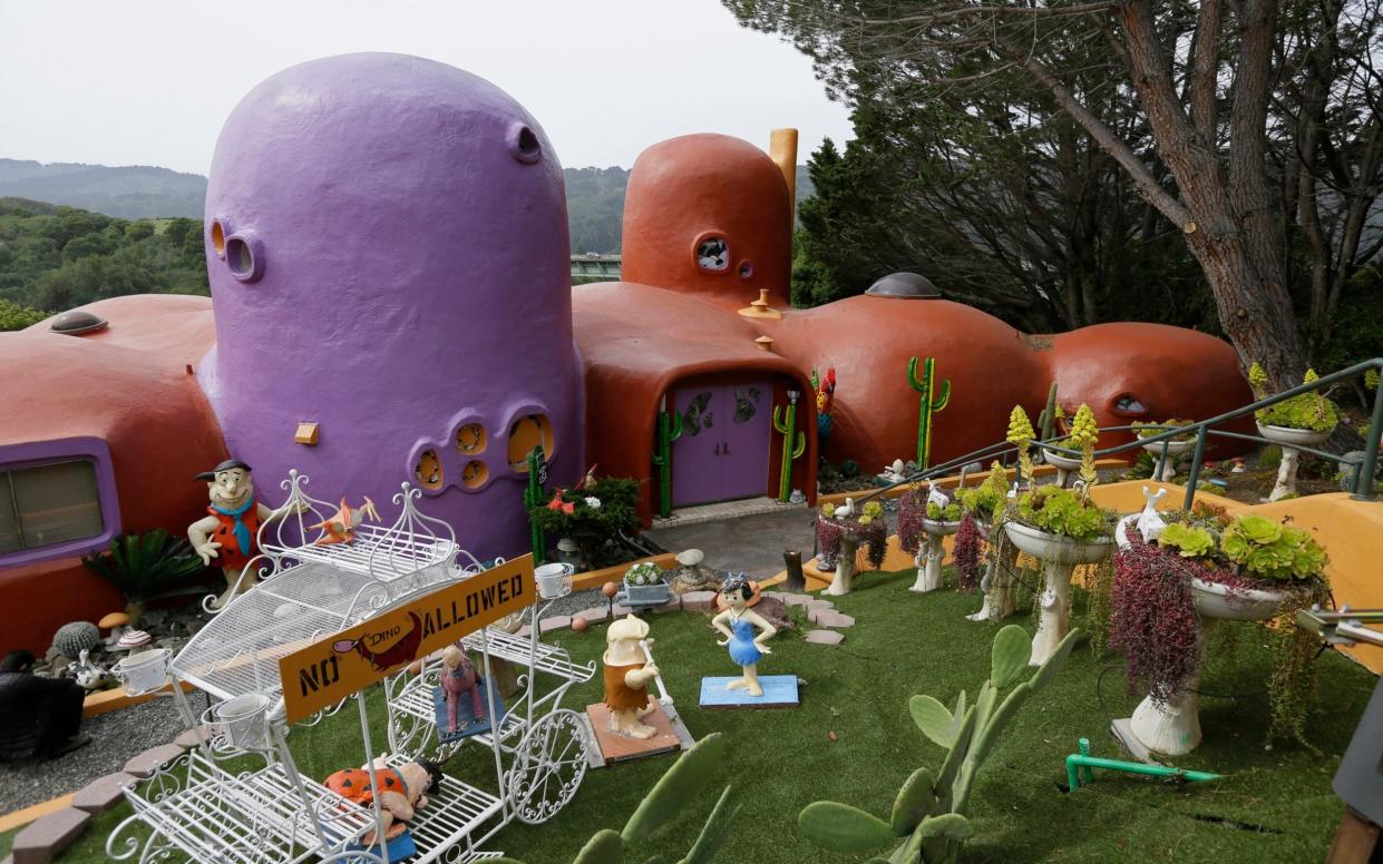 The San Francisco Bay Area suburb of Hillsborough is suing the owner of the house, saying that she installed dangerous steps, dinosaurs and other Flintstone-era figurines without necessary permits. - AP