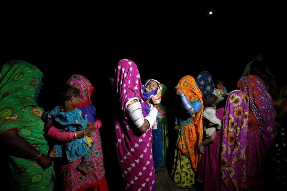 Farmers wearing traditional clothes gather to celebrate Holi, the Festival of Colours (Reuters)